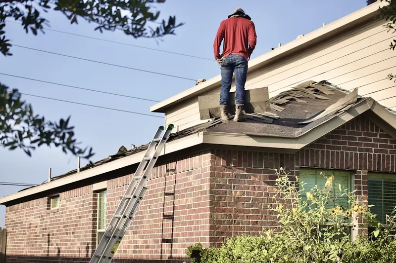 Professional roofer working on a residential roof in Winnetka